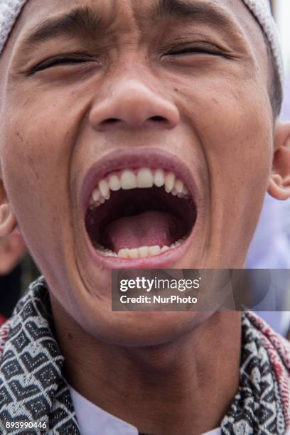 An Indonesian man shouts 'God is great' at a large demonstration against the United States' decision to recognize Jerusalem as the Capital of Israel...