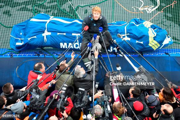 French skipper Francois Gabart answers journalists' questions upon his arrival at the end of his solo around the world navigation, on December 17,...