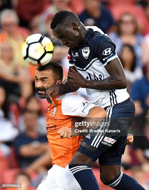 Fahid Ben Khalfallah of the Roar and Thomas Deng of the Victory challenge for the ball during the round 11 A-League match between the Brisbane Roar...