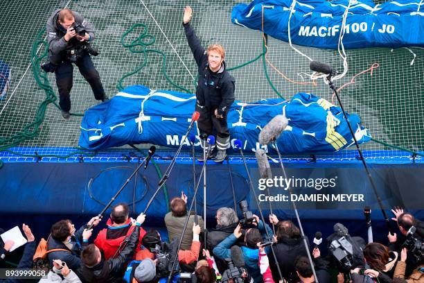 French skipper Francois Gabart answers journalists' questions upon his arrival at the end of his solo around the world navigation, on December 17,...