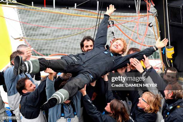 French skipper Francois Gabart celebrates with his team upon his arrival at the end of his solo around the world navigation, on December 17, 2017 in...