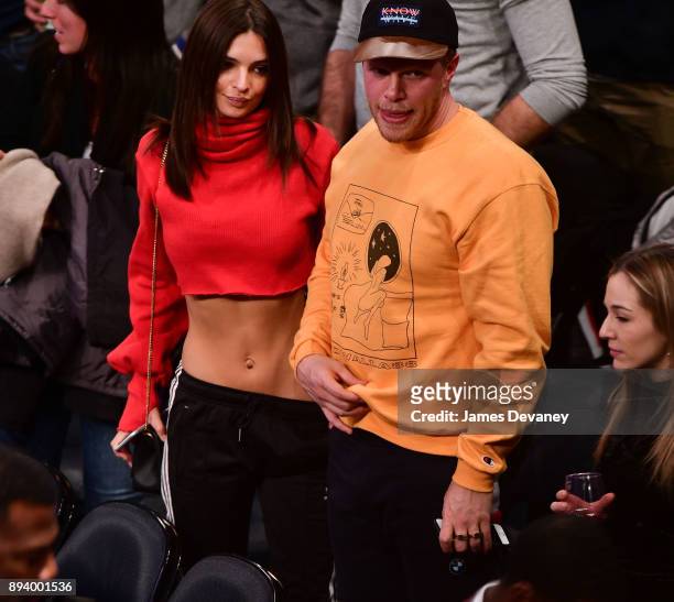 Emily Ratajkowski and guest attend the Oklahoma City Thunder Vs New York Knicks game at Madison Square Garden on December 16, 2017 in New York City.