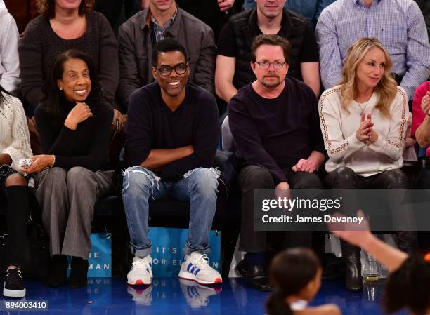 Rose Rock, Chris Rock, Michael J. Fox and Tracy Pollan attend the Oklahoma City Thunder Vs New York Knicks game at Madison Square Garden on December...