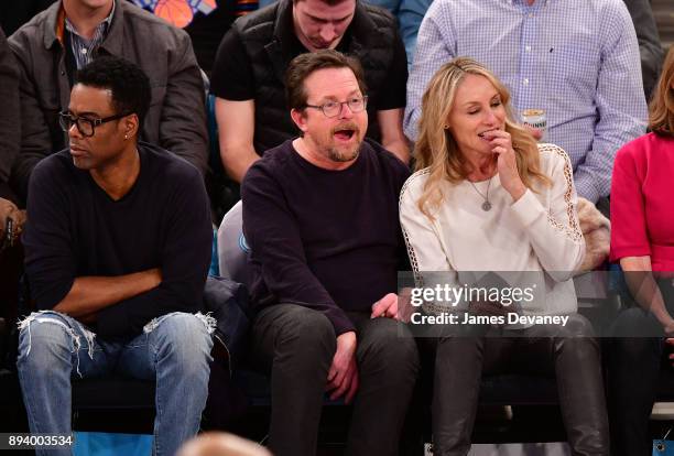 Chris Rock, Michael J. Fox and Tracy Pollan attend the Oklahoma City Thunder Vs New York Knicks game at Madison Square Garden on December 16, 2017 in...