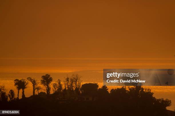 Smoke fills the sky over the ocean beyond homes threatened by the Thomas Fire on December 16, 2017 in Montecito, California. The National Weather...