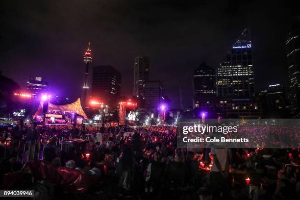 The crowd holds candles back dropped by the city during Woolworths Carols in the Domain on December 17, 2017 in Sydney, Australia. Woolworths Carols...