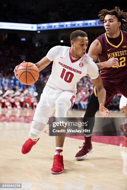 Daniel Gafford of the Arkansas Razorbacks drives to the basket against Reggie Lynch of the Minnesota Golden Gophers at Bud Walton Arena on December...