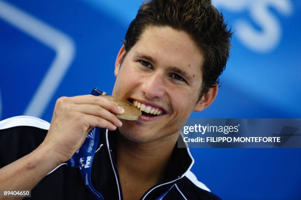 Bronze medalist Spain's Aschwin Wildeboer celebrates on the podium of the men's 100m backstroke on July 28, 2009 at the FINA World Swimming...