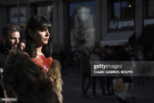 An activist of pro-animal rights group " Anima Naturalis", painted with fake blood, wears a fake-fur coat during a demonstration to protest against...