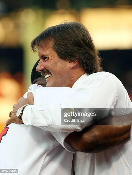 Former major league pitcher Dennis Eckersley congratulates former Boston Red Sox outfielder Jim Rice during his number retirement ceremony before the...