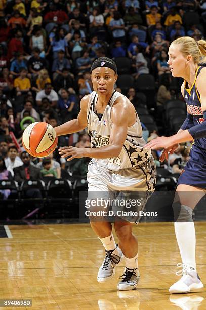 Vickie Johnson of the San Antonio Silver Stars moves the ball up court against Katie Douglas of the Indiana Fever during the game at AT&T Center on...