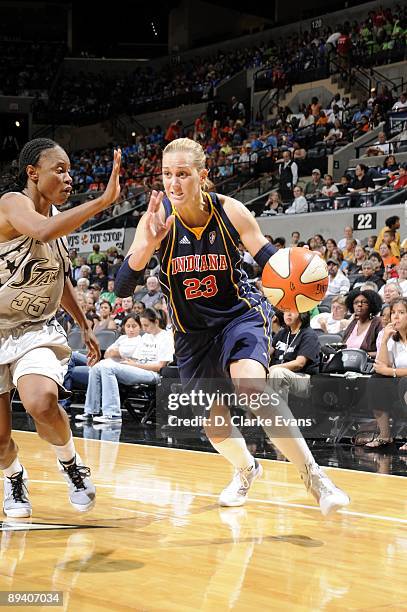 Katie Douglas of the Indiana Fever moves the ball up court against Vickie Johnson of the San Antonio Silver Stars during the game at AT&T Center on...