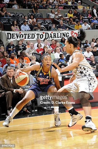 Briann January of the Indiana Fever makes a move against Helen Darling of the San Antonio Silver Stars during the game at AT&T Center on July 23,...
