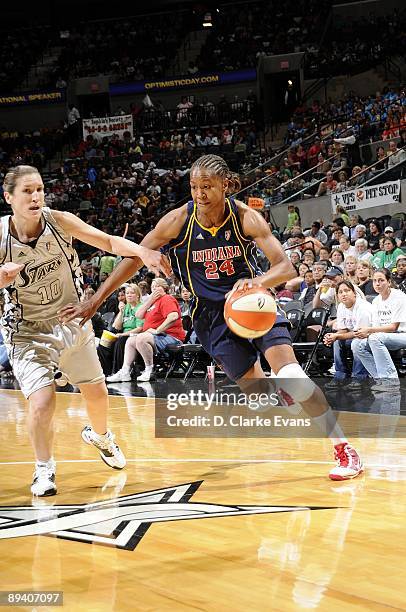 Tamika Catchings of the Indiana Fever drives to the basket against Belinda Snell of the San Antonio Silver Stars during the game at AT&T Center on...