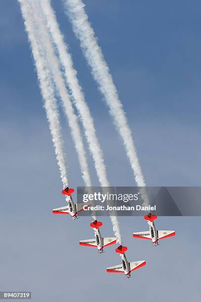The AeroShell aerobatic team, flying pre-World War II AT-6 training planes, performs during the Experimental Aircraft Association's 2009 AirVenture...