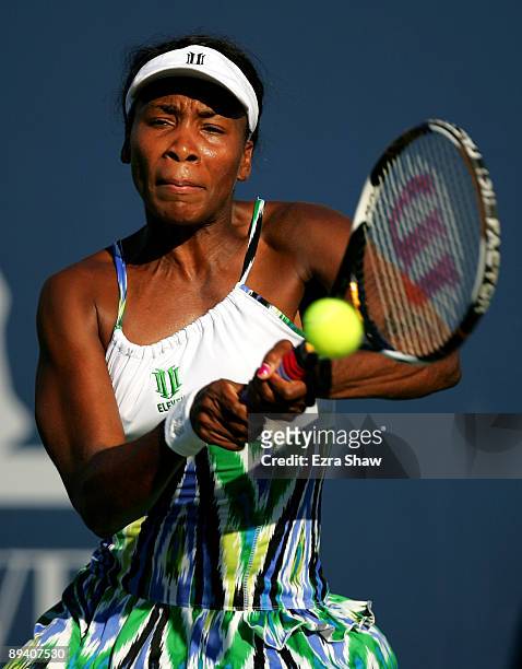 Venus Williams of the USA returns a shot to Stephanie Dubois of Canada during their match on Day 2 of the Bank of the West Classic at Stanford...