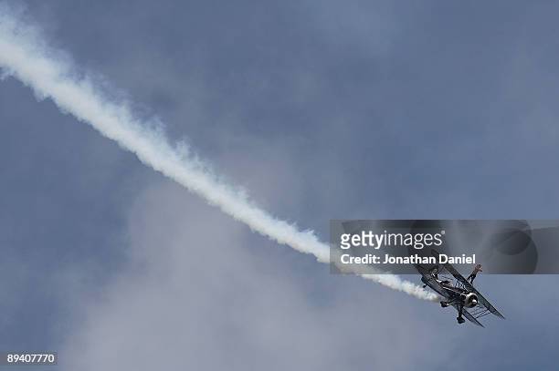 Pilot Kyle Frankin and wingwalker Todd Green perform during the Experimental Aircraft Association's 2009 AirVenture annual fly-in and convention on...