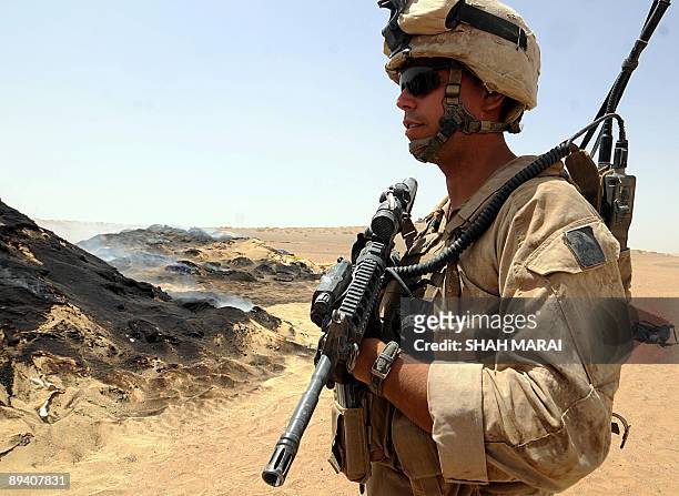 Afghanistan-vote-crime-drugs BY CHARLOTTE MCDONALD-GIBSON A picture taken on July 21, 2009 shows a US Marine of the 2nd Marine Expeditionary Brigade...