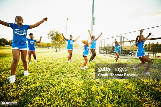 young cheerleaders practicing routine in park during early morning workout - black cheerleaders stock pictures, royalty-free photos & images