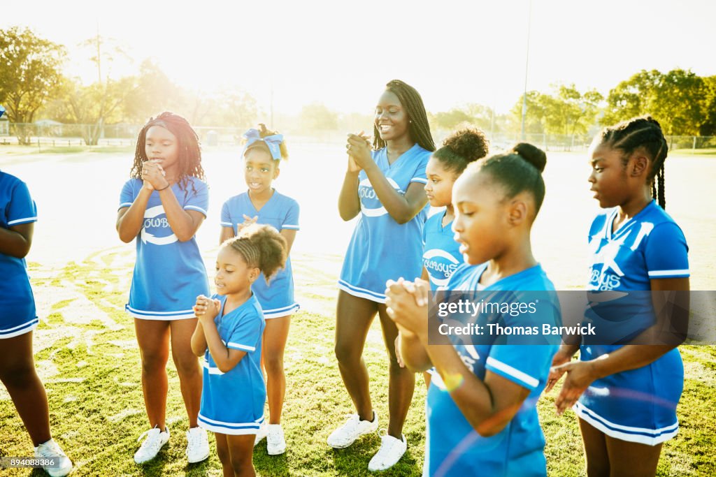 Smiling Young Cheerleaders Clapping Together While Practicing Routine ...