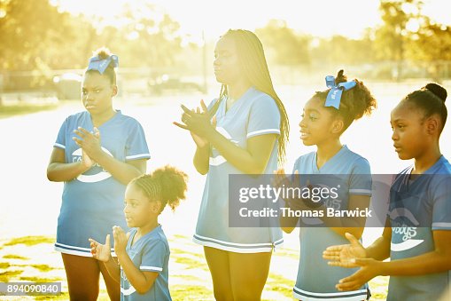 Smiling Cheerleaders Clapping Together While Practicing Routine During ...