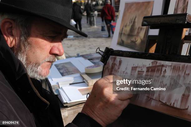 Venice. Italy. Street artist drawing a beautiful stamp of the city of Venice.