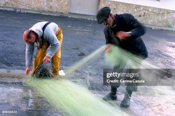 Finisterra, La Coruna. Galicia Fishermen weaving the nets