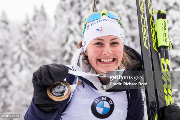 1st place Justine Braisaz of France poses following the podium ceremony after the IBU Biathlon World Cup Women's Mass Start on December 17, 2017 in...