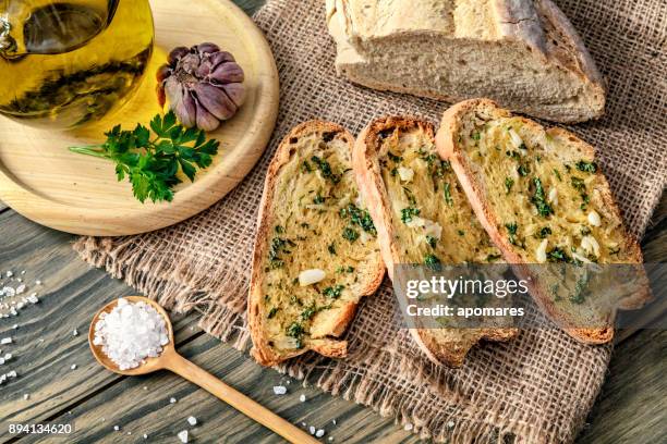 snack or appetizer of garlic basil and olive oil bruschettas - garlic stock pictures, royalty-free photos & images