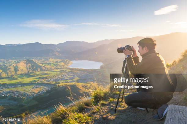 young traveler taking photo at mt cook famaus destination in new zealand - otago stock pictures, royalty-free photos & images