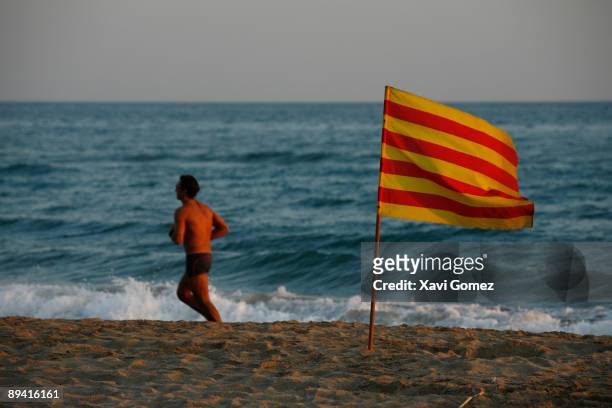 Catalonia, Spain. Catalonian flag in a beach.