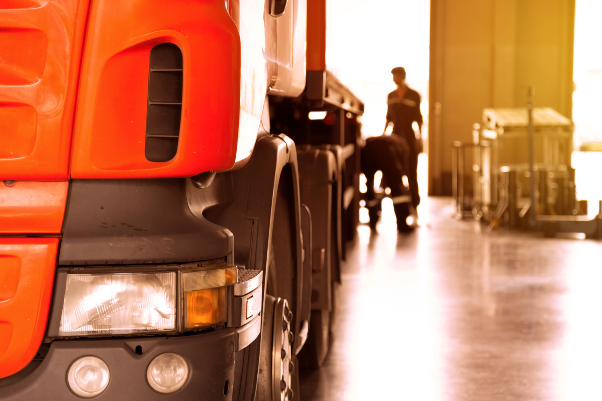 automobile mechanic checking truck in the garage with sunbeam, selective focus automobile mechanic checking truck in the garage with sunbeam, selective focus