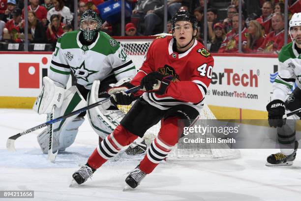 John Hayden of the Chicago Blackhawks skates in front of goalie Ben Bishop of the Dallas Stars in the first period at the United Center on November...