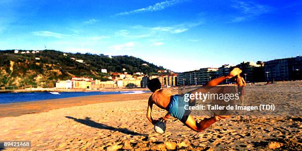 Playing football at La Zurriola Beach in San Sebastian.