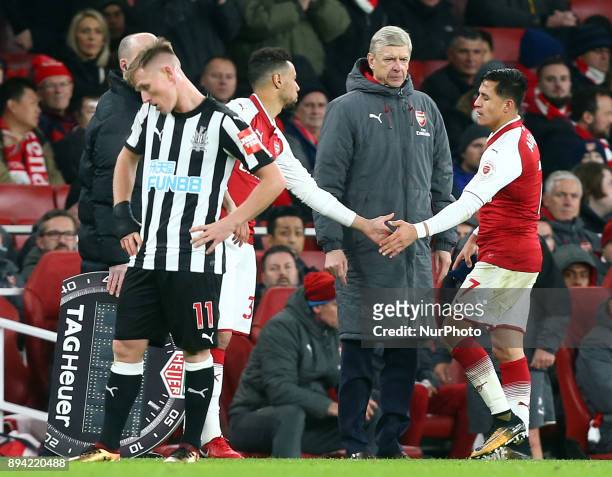 Arsenal's Alexis Sanchez whilst Arsenal manager Arsene Wenger look on during Premier League match between Arsenal and Newcastle United at The...