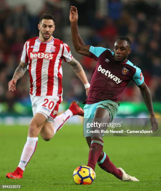 West Ham United's Michail Antonio and Stoke City's Geoff Cameron during the Premier League match between Stoke City and West Ham United at Bet365...