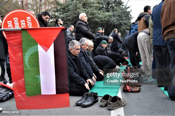 Turkish and Palestinian flags are displayed while men perform a prayer as pro-Palestinian protesters take part in a rally against U.S. President...