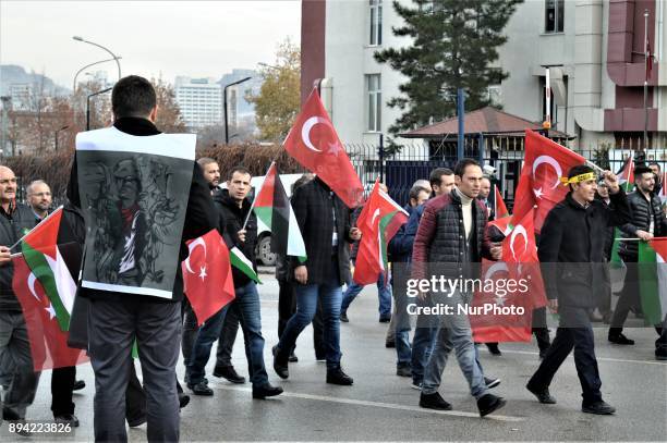 Men waving Turkish and Palestinian flags walk as pro-Palestinian protesters take part in a rally against U.S. President Donald Trump's recognition...