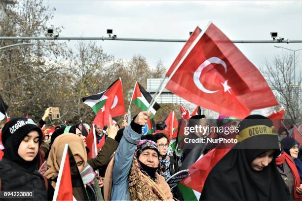 An elderly woman waves Turkish and Palestinian flags as pro-Palestinian protesters take part in a rally against U.S. President Donald Trump's...