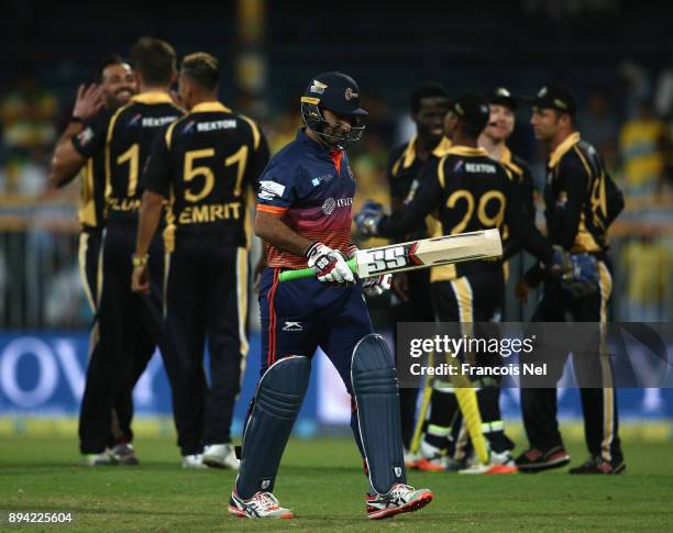 Asghar Stanikzai of Maratha Arabians leaves the field after being dismissed during the T10 League semifinal match between Kerela Kings and Maratha...