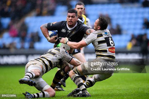 Nathan Hughes of Wasps is tackled by Kevin Gourdon and Zeno Kieft of La Rochelle during the European Rugby Champions Cup match between Wasps and La...