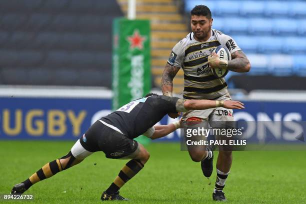 La Rochelle's Australian flanker Afa Amosa is tackled by Wasps' South African centre Juan De Jongh during the European Rugby Champions Cup pool 1...