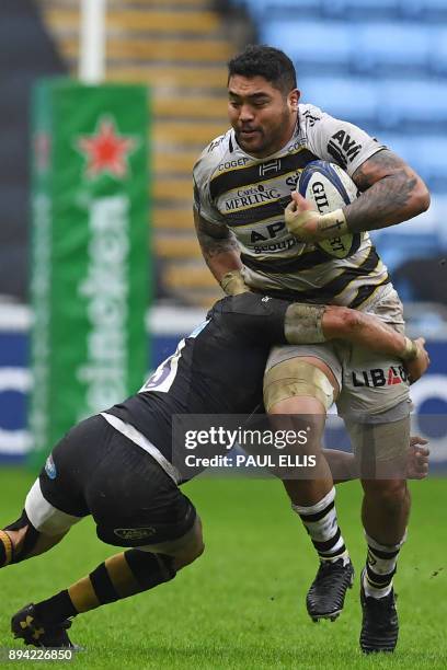 La Rochelle's Australian flanker Afa Amosa is tackled by Wasps' South African centre Juan De Jongh during the European Rugby Champions Cup pool 1...