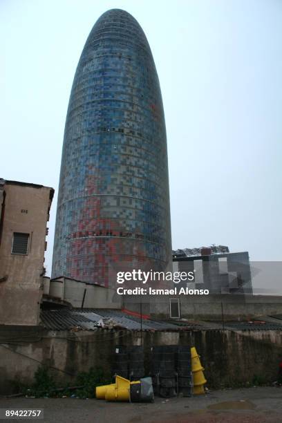 Shanty houses besides Torre Agbar, a building designed by Jean Nouvel.