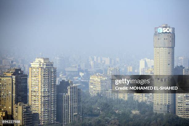 Picture taken on December 17, 2017 shows a view of the skyline of the Egyptian capital Cairo as seen from the Cairo Tower, with the skyline of the...