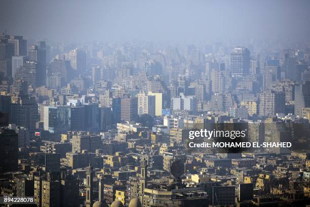 Picture taken on December 17, 2017 shows a view of the skyline of the Egyptian city of Giza, twin to the capital Cairo as seen from the Cairo Tower.