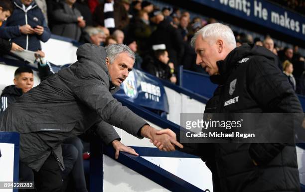 Jose Mourinho, Manager of Manchester United and Alan Pardew, Manager of West Bromwich Albion greet each other prior to the Premier League match...