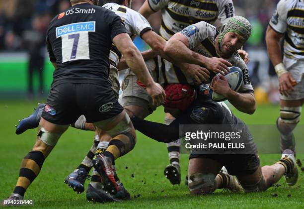 La Rochelle's French number 8 Kevin Gourdon is tackled during the European Rugby Champions Cup pool 1 rugby union match between Wasps and La Rochelle...