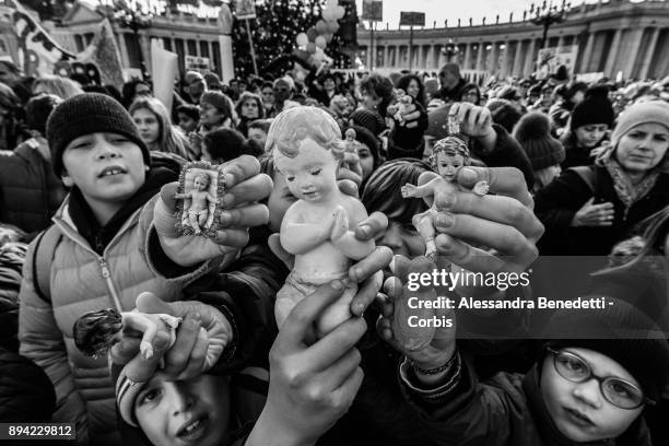Children and faithfuls have figurines of baby Jesus blessed by Pope Francis during his Sunday Angelus prayer in St. Peter's Square on December 17,...