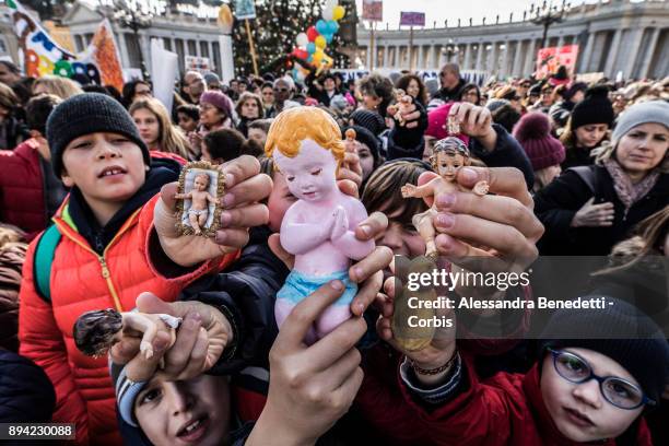 Children and faithfuls have figurines of baby Jesus blessed by Pope Francis during his Sunday Angelus prayer in St. Peter's Square on December 17,...